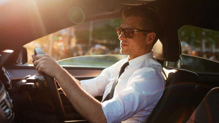 A man driving his car.